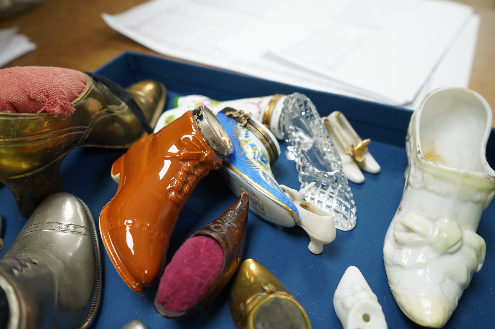 A collection of assorted miniature model shoes including pin cushions, one with modern silver mount